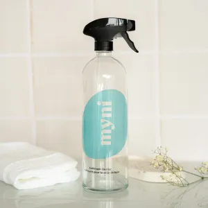 Bathroom cleaner bottle in glass