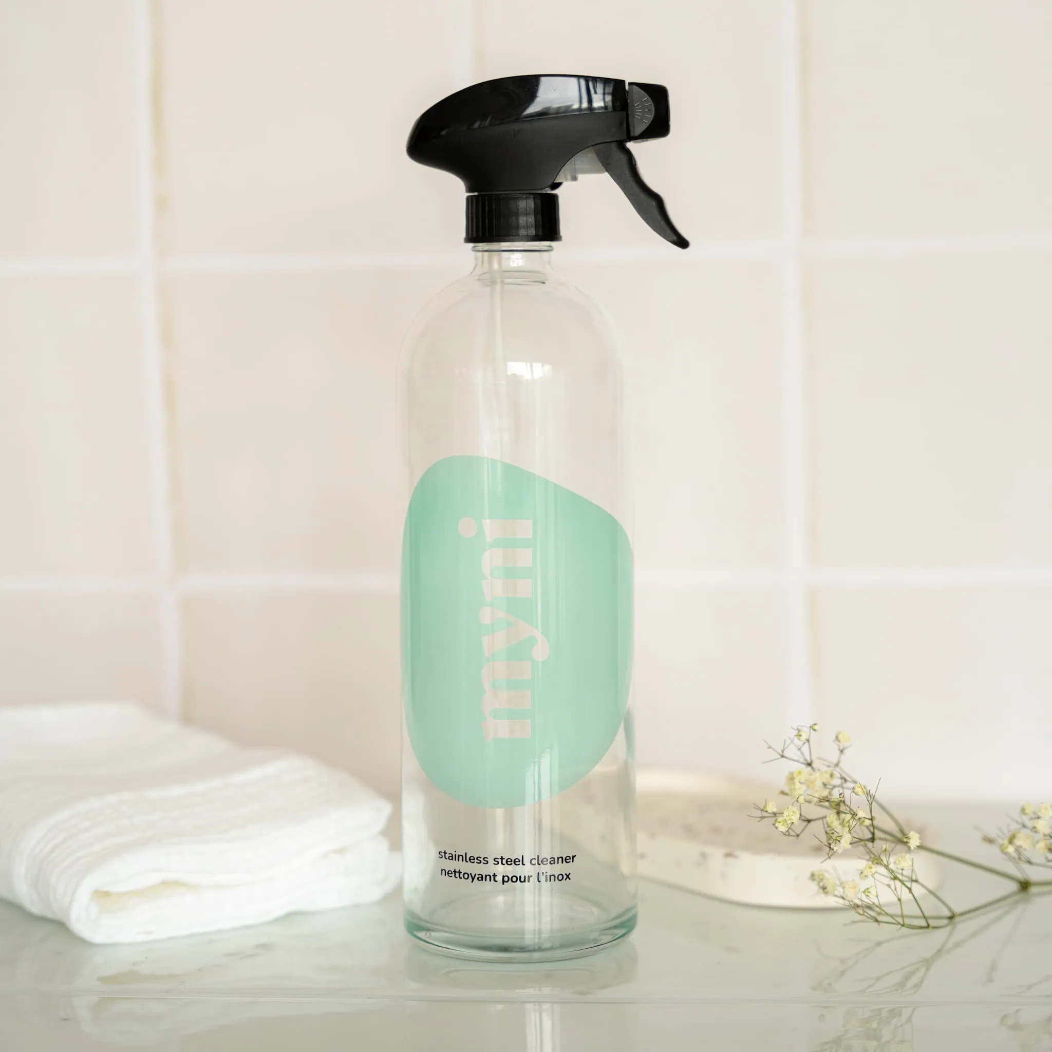 Stainless steel cleaner bottle in glass