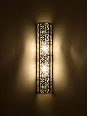 This stylish, shaded contemporary Moroccan wall light adds a touch of elegance and sophistication to any home decor.