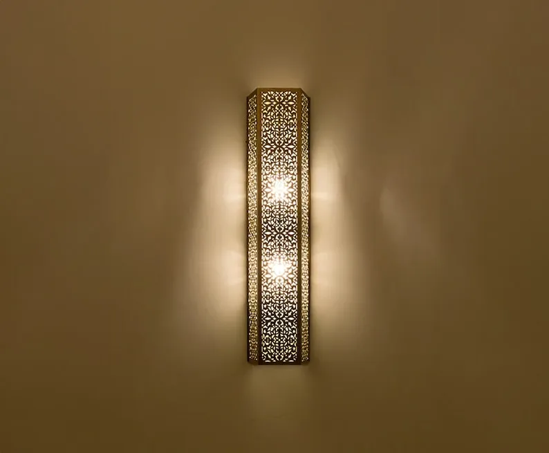 This stylish, shaded contemporary Moroccan wall light adds a touch of elegance and sophistication to any home decor.